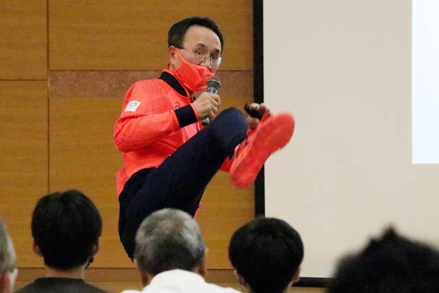燕市スポーツ協会のスポーツ協会の講演会で体を使って試合の再現で熱く講演する林晃さん