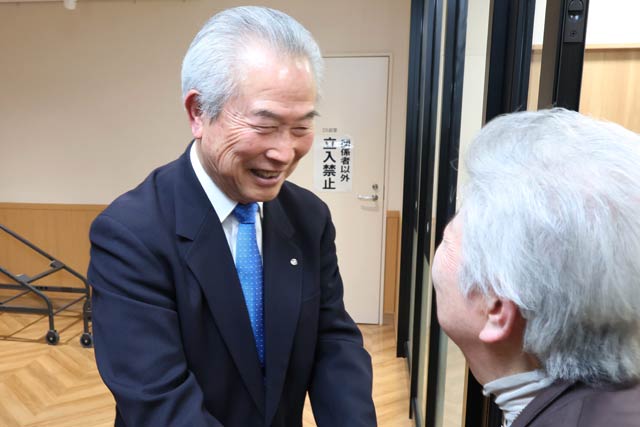 支援者と握手して送る佐野氏