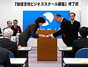 蛯名新潟経営大学長から修了証と科目認定証を受け取る受講生