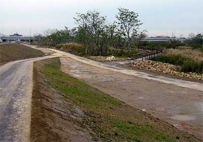 来年3月のオープンに向けて工事が進む中ノ口川河川公園(仮称)の建設現場、写真奥に見えるのが県央大橋