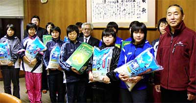 JAにいがた南蒲からプレゼントされたコメと洋ナシを手に三条東高等学校陸上部女子チーム