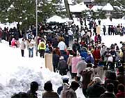 雪に覆われた本堂は参拝客でにぎわう