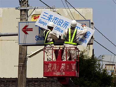 28日行われた下田村役場前の案内標識の修繕作業