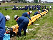 「三角形連続可搬式膨張堰」による水防工法