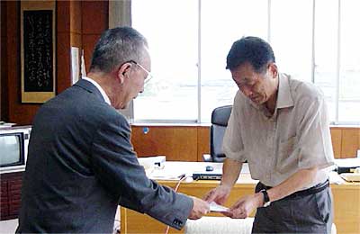 高橋三条市長(右)に『熊谷蓮生坊』の目録を手渡す藤井さん(左)