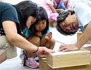 親子で真剣な表情で工作