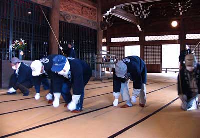 28日、本成寺で行われたすす払いで本堂の畳たたきをする壇信徒
