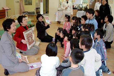 29日、三条市立嘉坪川保育所で行われた終了式後の謝恩会で、年長児と保護者からのサプライズプレゼントの似顔絵を保育士にプレゼント