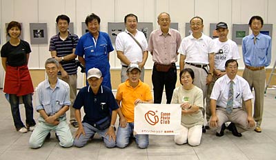 展示作業を終わって記念撮影するキャノンフォトクラブ新潟県央支部会員