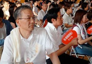 試合を見詰める新潟県央工高野球部を甲子園に送る会の梨本事務局長（手前）