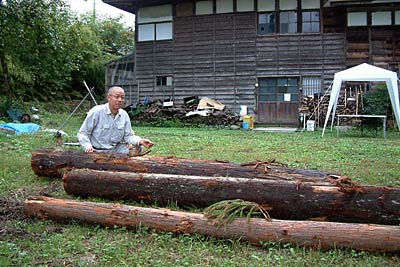 会場の庭月テラ小屋で13日に雨宮氏がはつる丸太と馬場会長