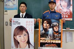 秋の火災予防運動のポスターを手に三条市消防本部職員