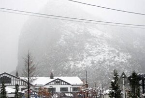 「しただブログ」に掲載された、かもしか病院から「いい湯らてい」越しにそびえ立つ八木ヶ鼻を白くした雪