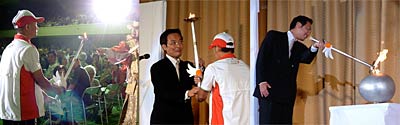三条市炬火リレーで炬火を国定市長へつなぐ
