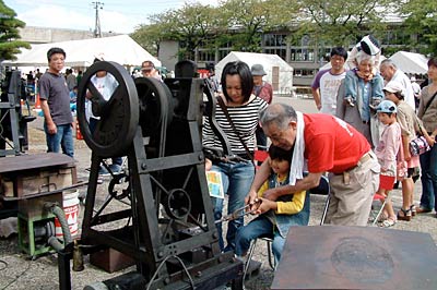 20日開かれた「越後三条鍛冶まつり'09」のスプリングハンマー体験