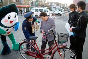 三条市内の駅駐輪場で高校生も参加して自転車に2個以上の鍵をつけて防犯防止を呼びかける「愛鍵ツーロック運動」