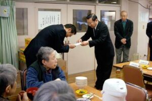広域養護老人ホーム「県央寮」で管理者の国定三条市長に寄付の目録を手渡す角利産業の加藤社長