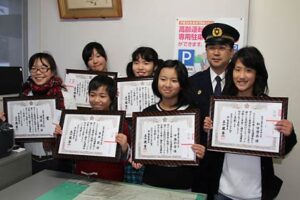 世話になった礼に燕市粟生津小5、6年生6人が夜光反射材を取り付けたエコバッグを地元の高齢者に贈呈