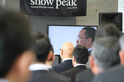山井社長のあいさつのようすをモニター画面に映しながら