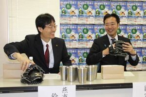 17日行われる2011プロ野球イースタン・リーグ震災復興支援チャリティーマッチ「三機スタ野球祭り2連戦」の記者会見でグローブをはめて童心に返る鈴木燕市長(左)と国定三条市長(右)