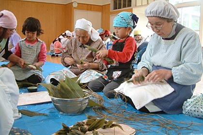  三条市四日町交流センターで同施設利用者と四日町児童館の小学生が笹団子作り