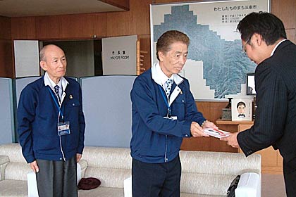 車いす30台の寄付の目録を手渡す左からアーネストの山沢総務部取締役部長、鈴木社長、そして国定三条市長