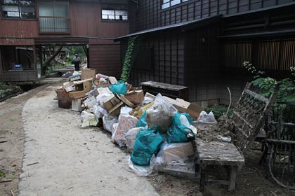 嵐渓荘は記録的豪雨で横を流れる守門川が増水してあふれたために床上浸し水につかった家具などを外に運び出した
