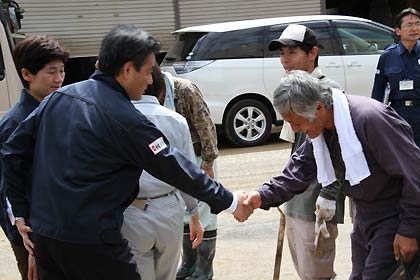 7日、三条市を現地視察に訪れ、牛野尾地内の住民と握手する岡田幹事長