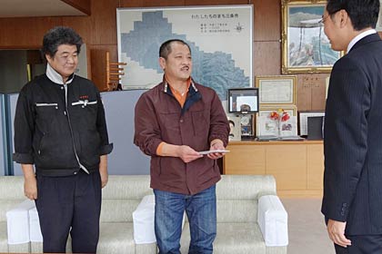 国定市長に水害義援金を手渡す三条中央青果卸売市場の塩野会長(中央)と田巻副会長(左)