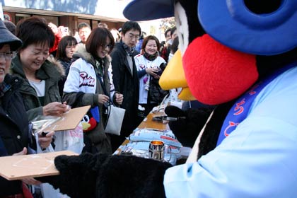 つば九郎米にサインをするつば九郎