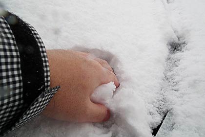 素手でフロントガラスの雪をつかんでみる