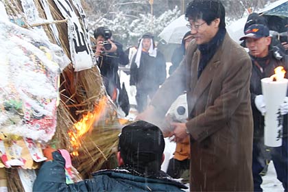 鈴木市長もわらをくべて点火