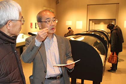 作品解説会後、展示会場でも参加者に解説する松浦さん
