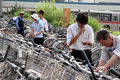 駐輪場で高校生が自転車の鍵かけをチェック