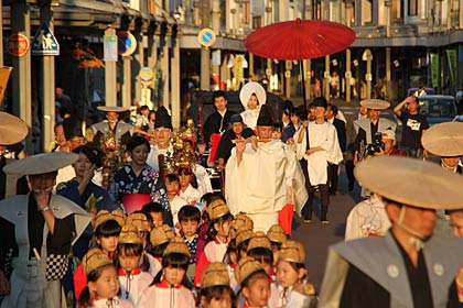 西日を受けて厳かに行列が進む