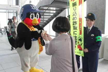 20日に燕市新庁舎で燕署員と振り込め詐欺防止を呼びかけるポケットティッシュなどを配布したつば九郎