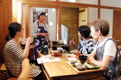 「みんくる」へ出張して開かれた「いわむろや」の「やさいのへや」、後ろに立って話しているのがカリスマ農家シェフ、永塚さん
