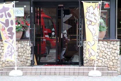 ガス爆発と思われる事故があった焼き肉店の正面玄関、ドアのガラスも割れた