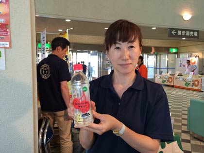  「サクランボウォーター」を手に南陽市ブランド推進室の岩瀬さん