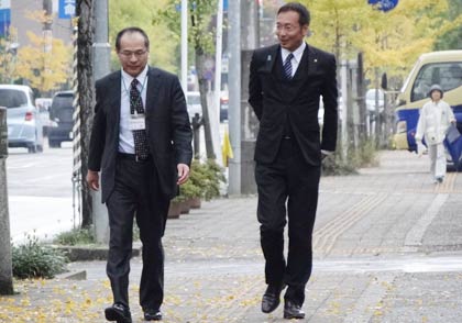 職員に迎えられて登頂する国定市長
