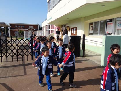 はっぴを着てひまわり保育園を出る幼年消防クラブの園児