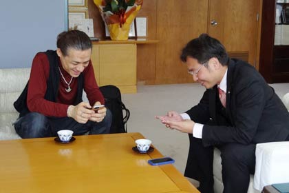 電話番号を交換するTOKUさんと国定市長