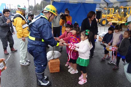 三条市域除雪機械安全運行祈願祭と出動式で市道、県道、国道の除雪者をそれぞれ担当する代表の3人に月岡保育所の幼児から金色に輝く手作りの除雪機械の鍵を手渡す