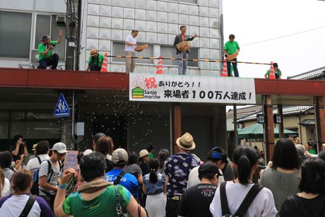 100万人達成を祝ってアーケードの上からもちまき