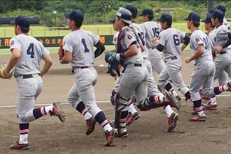 グラウンドへ飛び出す慶応大選手