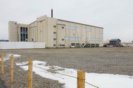 解体が終わってさら地になった三条市総合体育館跡地と奥に解体中の三条市体育文化センター