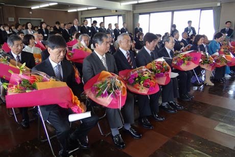 花束を受けて謝辞を聞く退職者