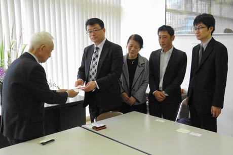  左から上石三条市社協会長、崎山興紀さんの長男の信彦さん、妻ミツ子さん、二男興治さん、三男賢三さん