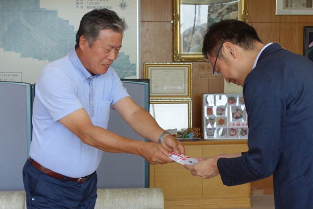 国定市長に寄付金を手渡す鹿峠会の近藤会長(左)