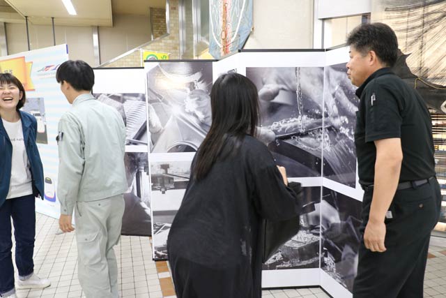 燕三条駅改札内で長岡造形大生と大湊文吉商店がコラボレーションした装飾の展示作業